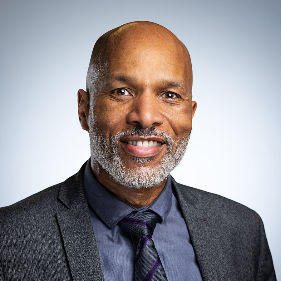 Clive Hodge, new College Principal, Uxbridge College. He is wearing a grey suit jacket, blue shirt and tie.