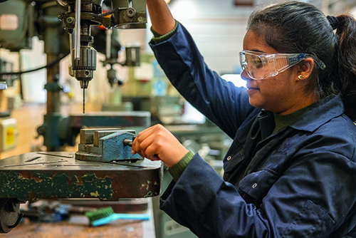 Engineering student using a drill