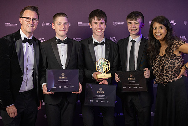National Innovation Challenge Secondary School Category winners Robert O'Callaghan, Matthew Rawcliffe and Sean Carlyle from St Bede’s Catholic High School, holding thier awards and smiling with HRUC CEO Keith Smith and TV presenter and children’s author, Konnie Huq.