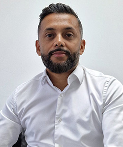 Iqbal Vaza - Chief Executive, The Education Space - wearing a white shirt with a white background behind him. 
