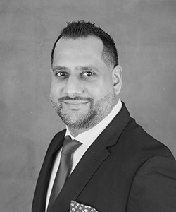 Pally Randhawa dressed in a suit with a tie and polka dot handkerchief in his breast pocket 