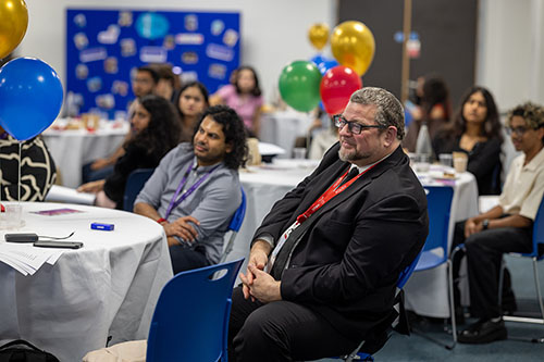 Tim Wells of INTERNeX sitting in audience at the Turing Scheme Overseas Placements ceremony.