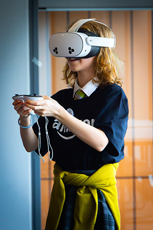 One of the Amazon’s Girls' Tech Day attendees with VR goggles on 