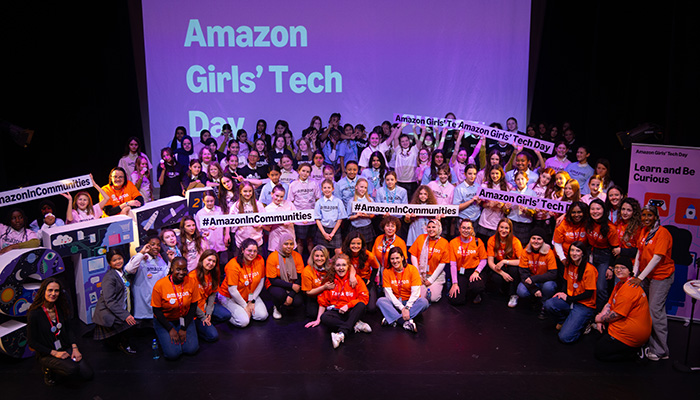 Group shot of all attendees on stage at the Amazon’s Flagship Girls' Tech Day Event.