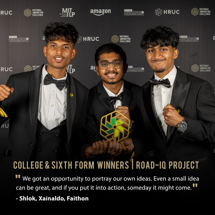 NIC 2026 Colleges category winners - Shlok, Xainaldo and Faithon from Uxbridge College - holding their award and smiling. They are wearing tuxedos and standing in front of a backdrop full of logos.