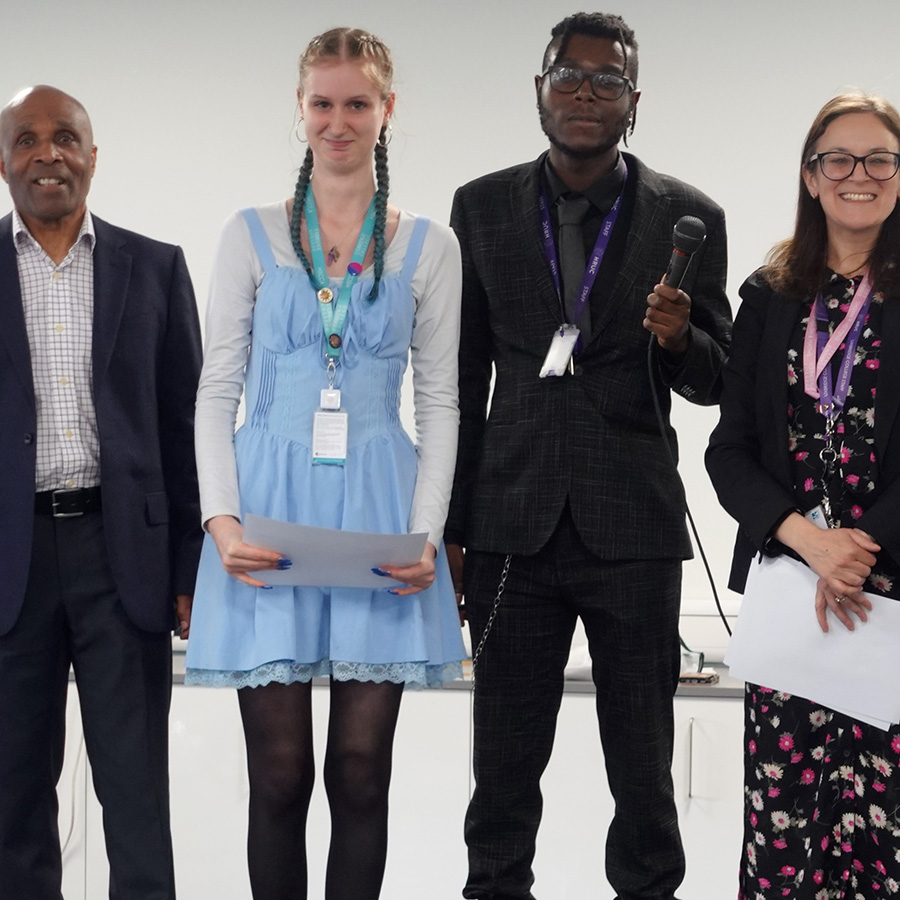 Bianca Fanciullacci, Head of School for English and Maths with Cecil Browne, Joshua Kandapah and a female Uxbridge College English GCSE student. She is holding her certificate for the Young Writers Stranger Sagas competition.