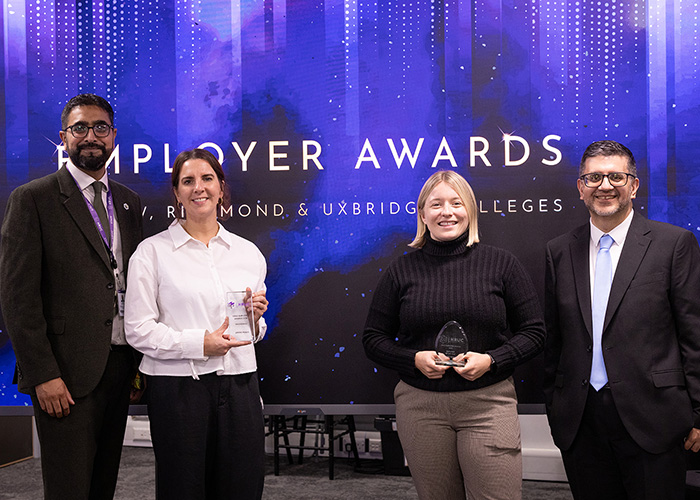 Yaseen Akhtar, Managing Director of the West London Institute of Technology, HRUC standing with two female representatives from AtkinsRéalis and Asif Khan -Assistant Principal - IoT, Engineering and Technologies. The two women are holding awards for HRUC Employer of the Year and Engineering Employer of the Year. They are at the Employer Awards evening at Uxbridge College and there is a sparkly blue backdrop behind them.