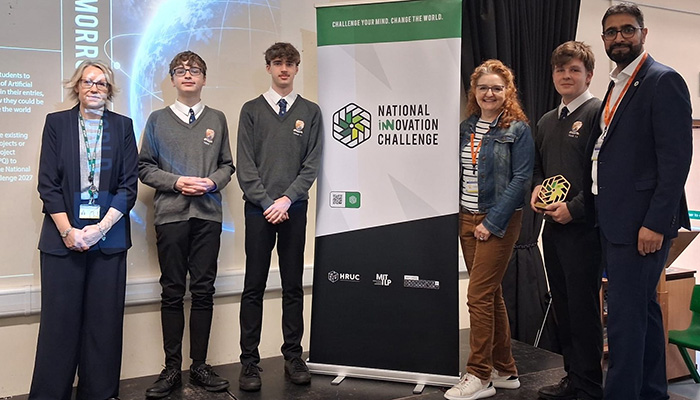Yaseen Akhtar, Managing Director of the West London Institute of Technology, and Dr Niamh Shaw, NIC ambassador with staff and students from St Bede's College. 3 of our NIC finalists are featured and standing next to a NIC pull up banner.